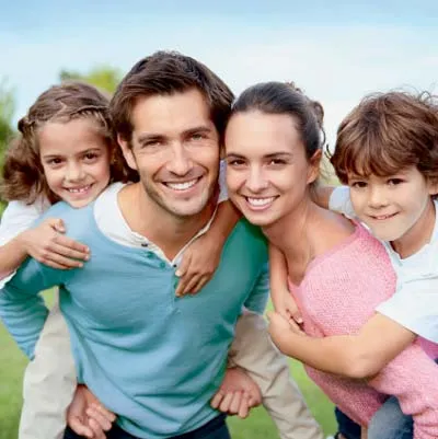 Two parent smiling with their young kids