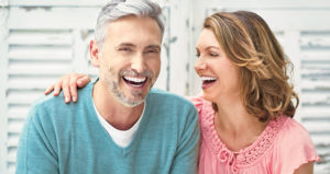 Semi-retired couple shares a laugh to reveal their dental implants