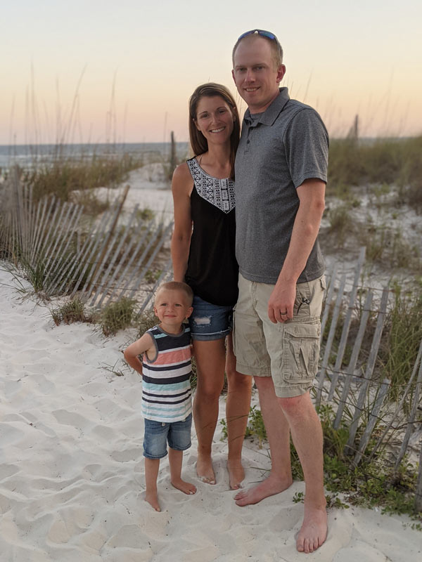 Dr. Jake Voyles with his wife and sun at the beach